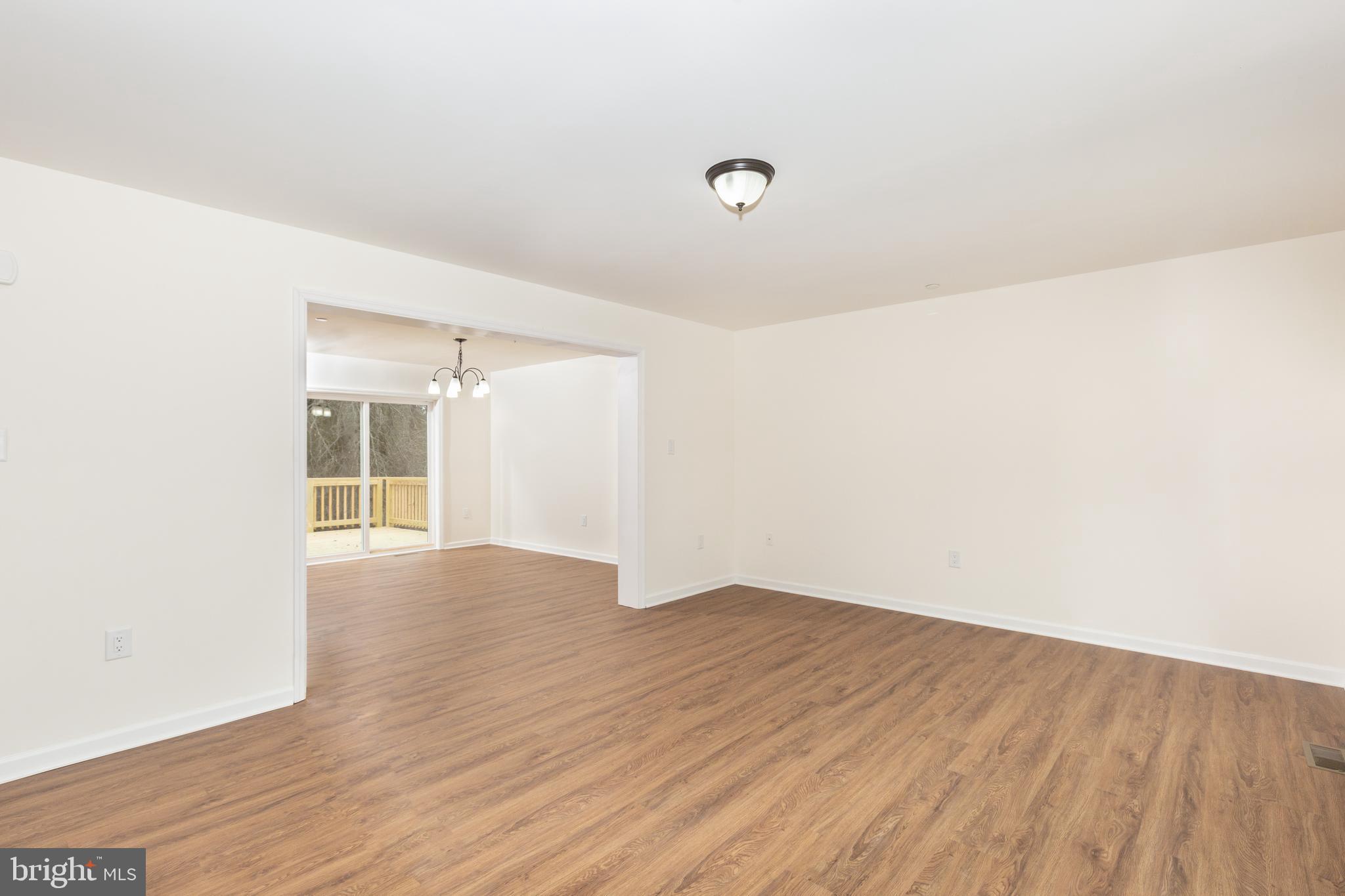 3406 Viewridge Circle Manchester, MD 21102 - Photo 27 of 57 a view of an empty room with wooden floor and a window