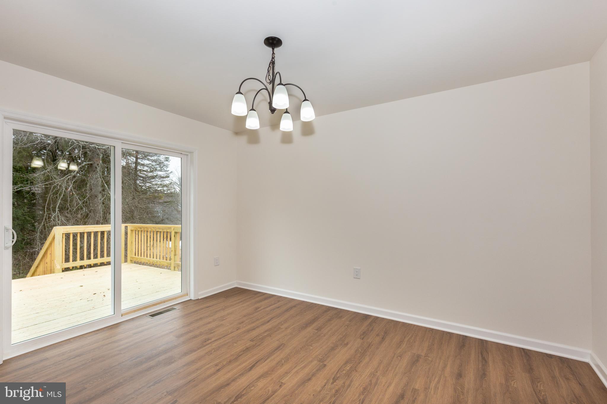 3406 Viewridge Circle Manchester, MD 21102 - Photo 28 of 57 a view of an empty room with wooden floor and a window