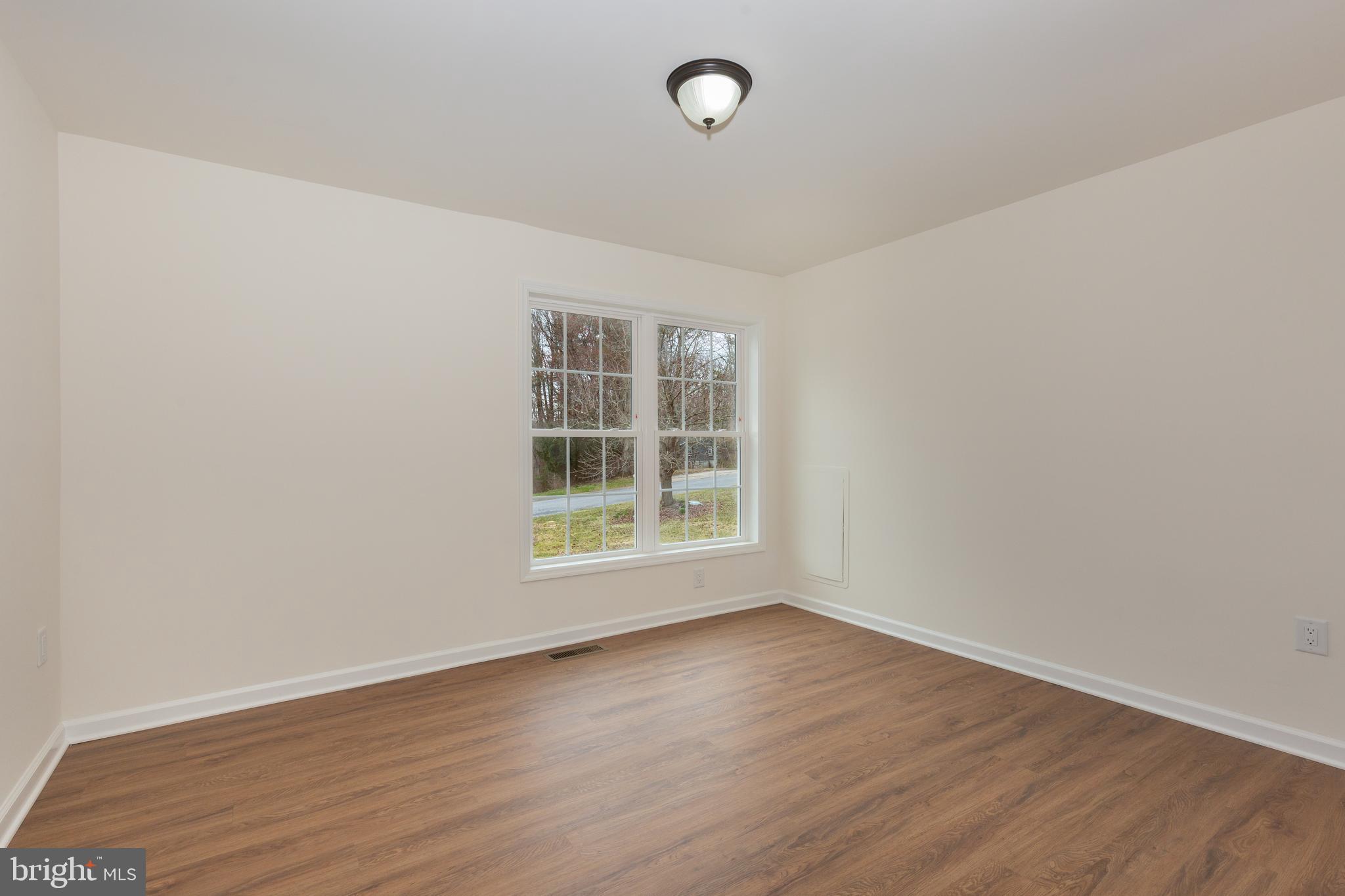 3406 Viewridge Circle Manchester, MD 21102 - Photo 30 of 57 an empty room with wooden floor and windows