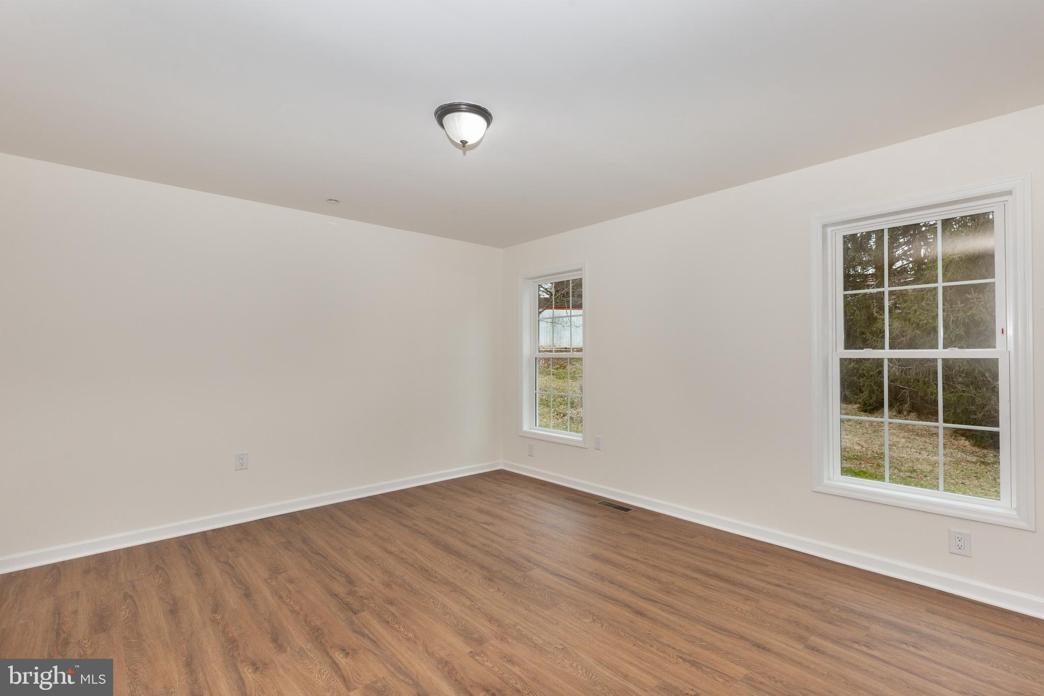 3406 Viewridge Circle Manchester, MD 21102 - Photo 32 of 57 an empty room with wooden floor and windows