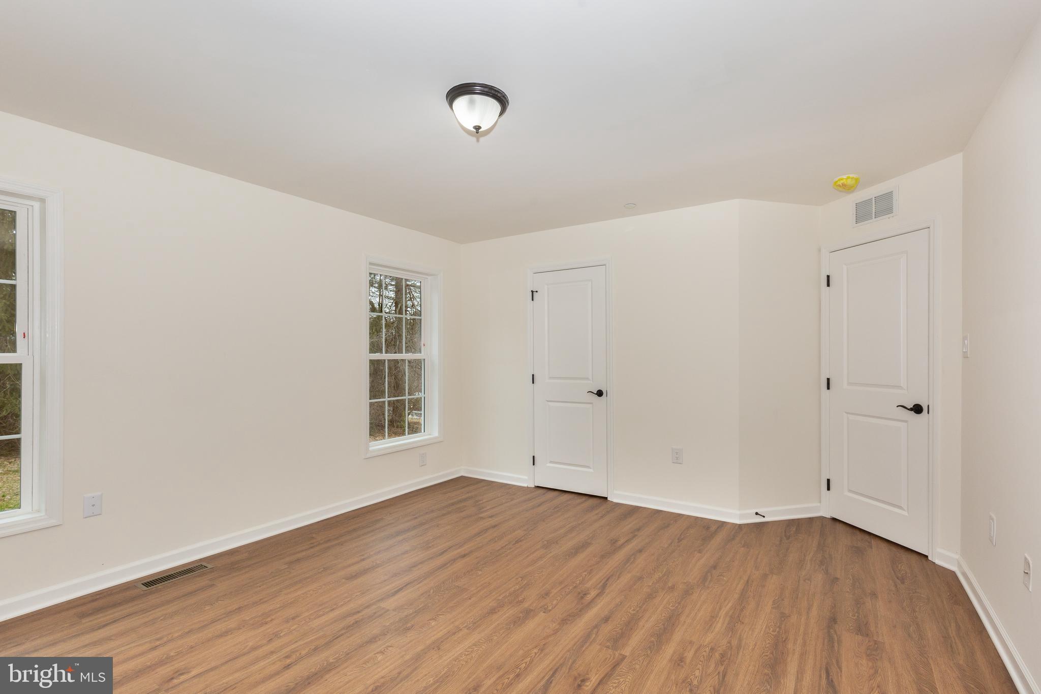 3406 Viewridge Circle Manchester, MD 21102 - Photo 33 of 57 a view of an empty room with wooden floor and a window