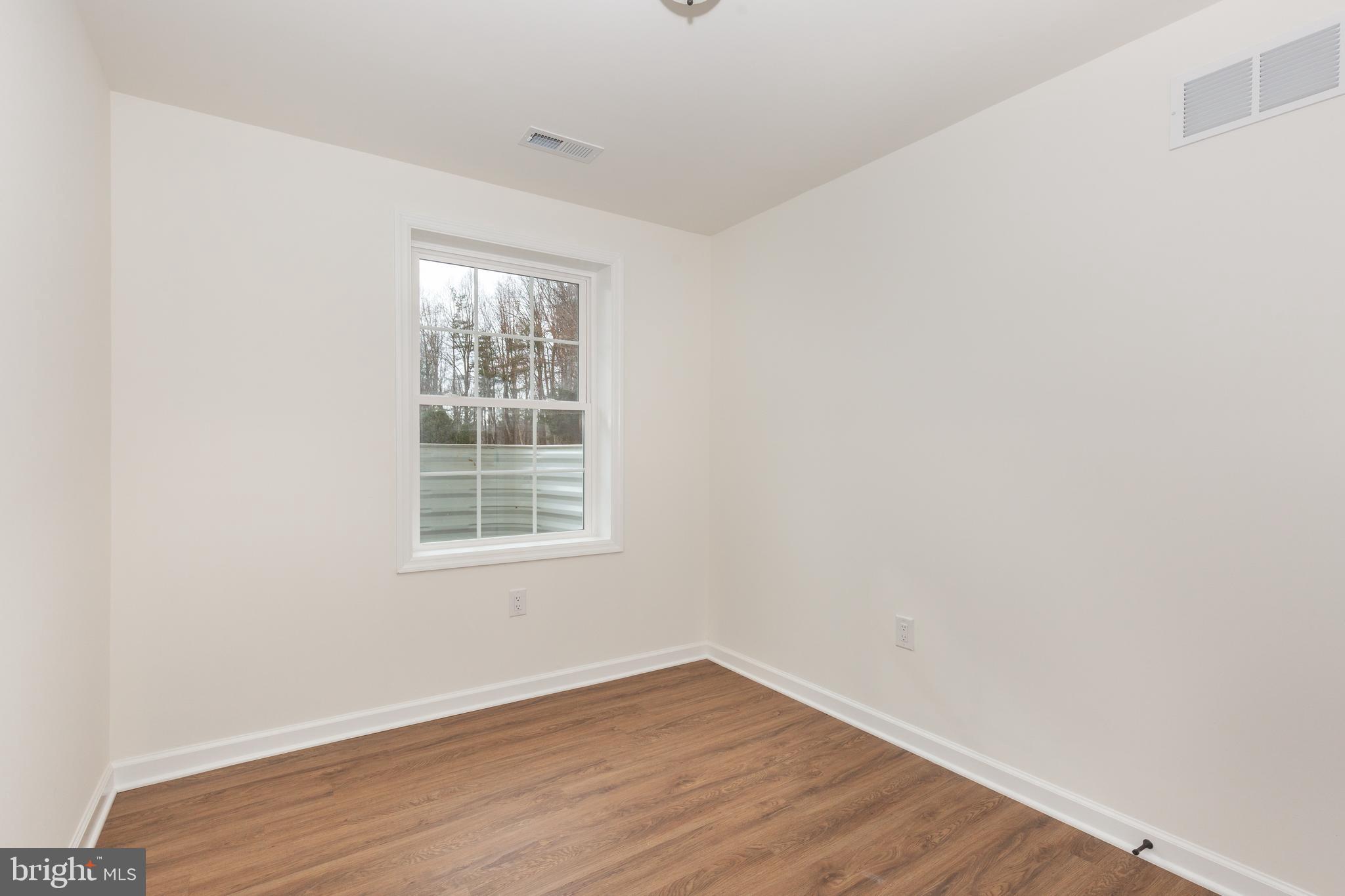3406 Viewridge Circle Manchester, MD 21102 - Photo 38 of 57 an empty room with wooden floor and windows