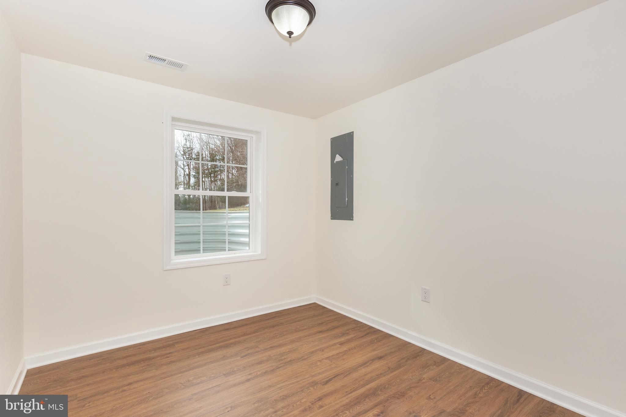3406 Viewridge Circle Manchester, MD 21102 - Photo 40 of 57 an empty room with wooden floor and windows