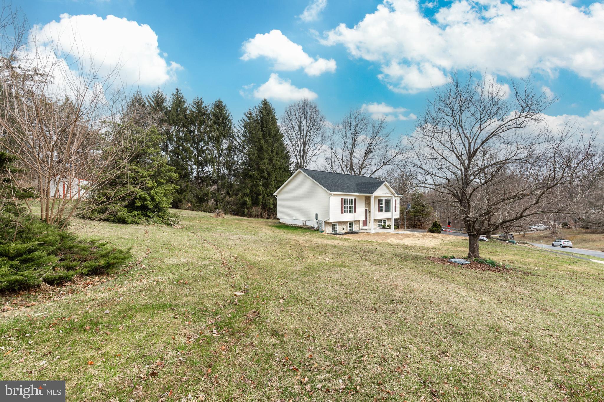3406 Viewridge Circle Manchester, MD 21102 - Photo 52 of 57 a view of a large house with a big yard and large trees