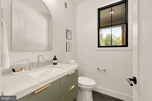 a bathroom with a sink toilet and vanity