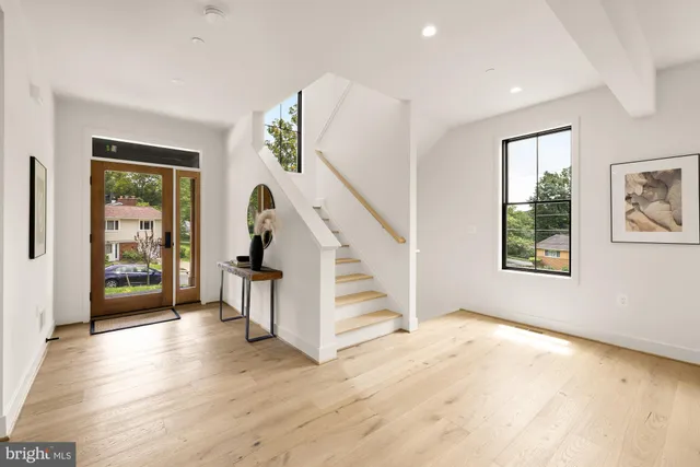 a view of an entryway with wooden floor and windows
