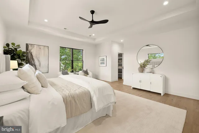 a view of a hallway with wooden cabinets with large window