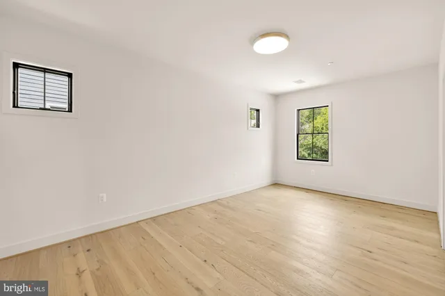 a view of a kitchen with wooden floor and a sink