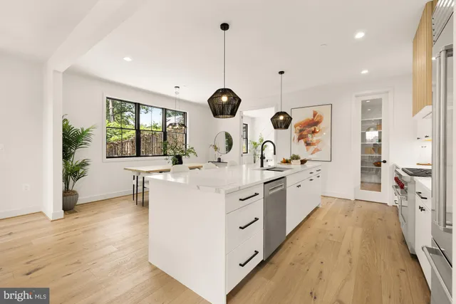 a kitchen with stove a sink and a refrigerator