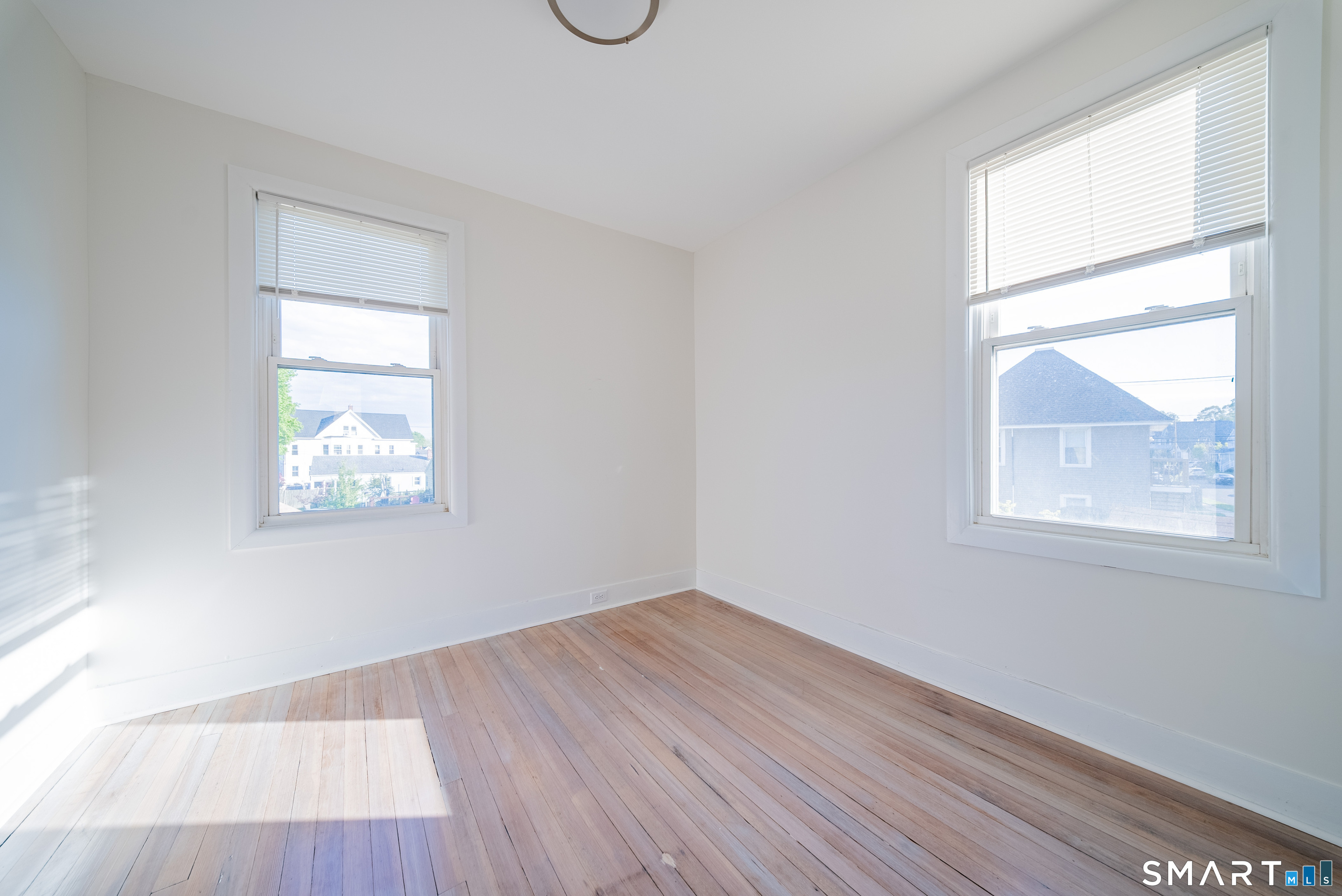 50 Jones Street West Haven, CT 06516 - Photo 13 of 21 an empty room with wooden floor and windows