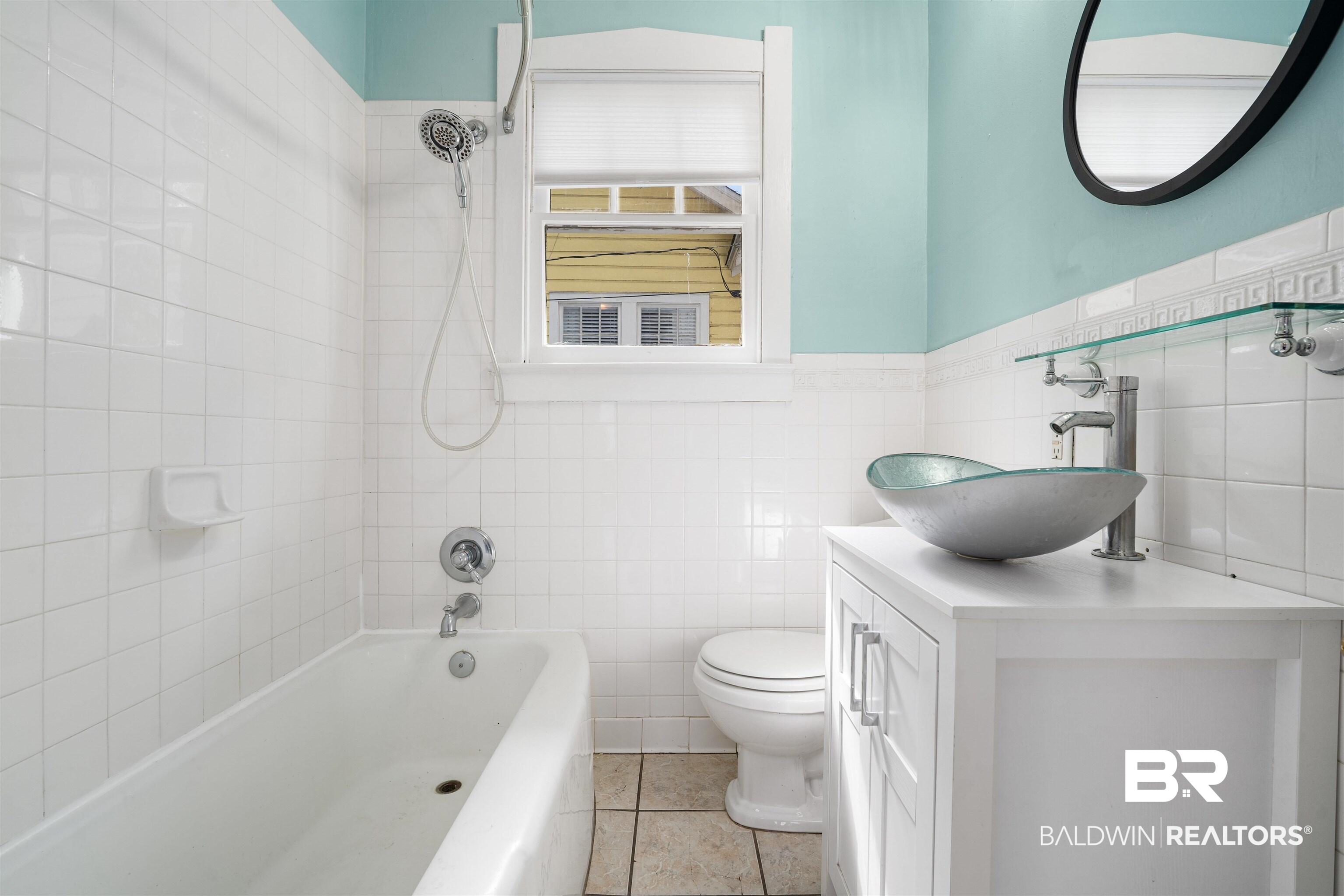 118 Mohawk Street Mobile, AL 36606 - Photo 14 of 26 Bathroom with tile walls, vanity, shower / tub combination, wainscoting, and light tile patterned floors