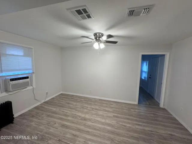 a view of a kitchen with a sink and a refrigerator