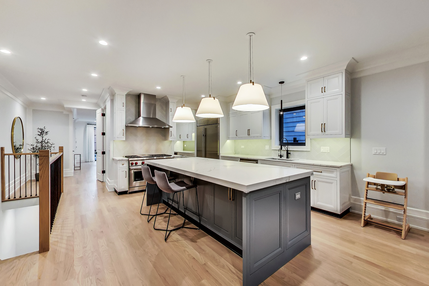 1911 North Mohawk Street, Unit 1 Chicago, IL 60614 - Photo 2 of 6 a kitchen with a sink a stove a refrigerator and chairs