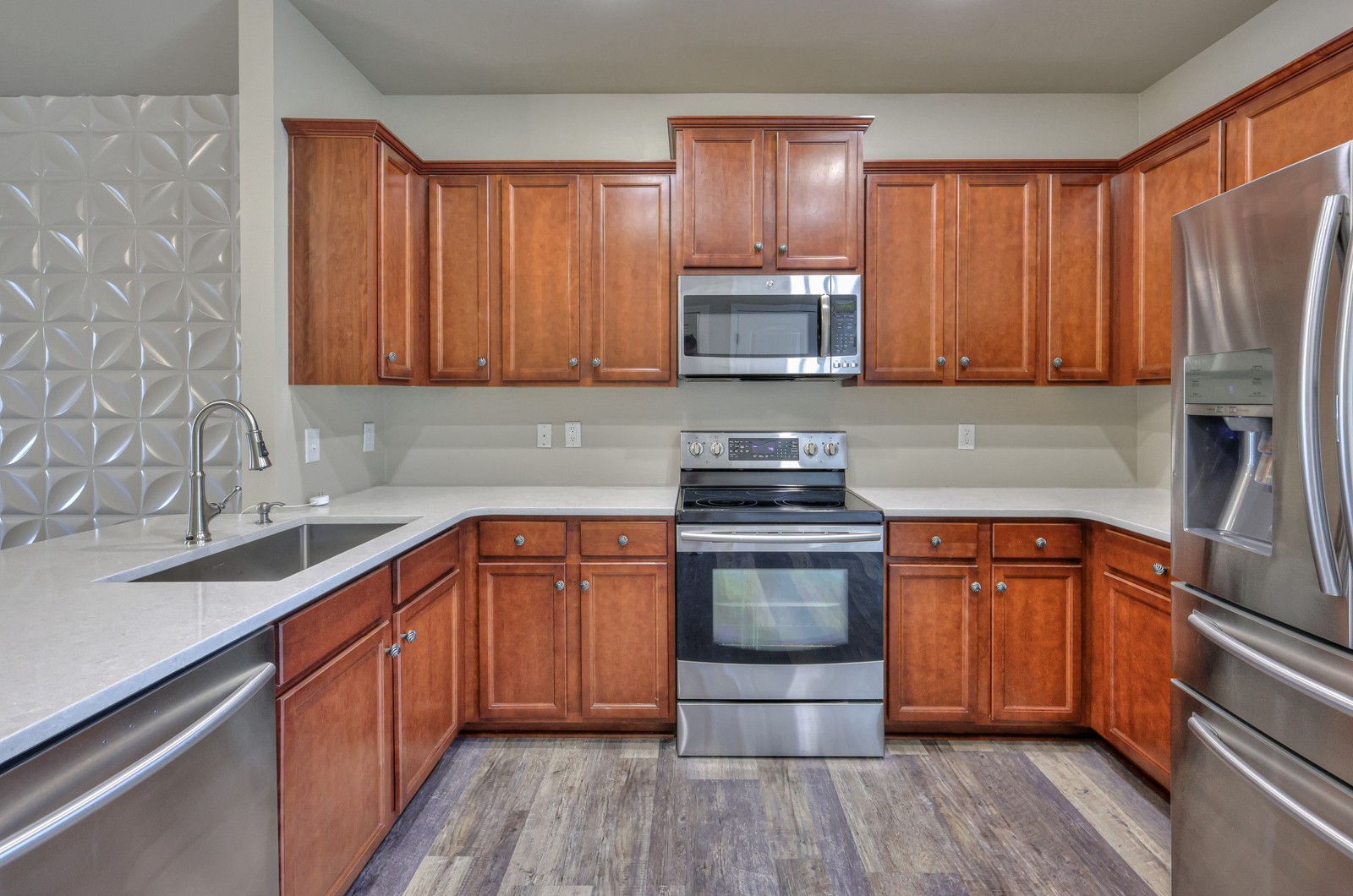 911 Brigade Loop Murfreesboro, TN 37128 - Photo 8 of 29 a kitchen with stainless steel appliances granite countertop wooden cabinets a stove top oven a sink and dishwasher