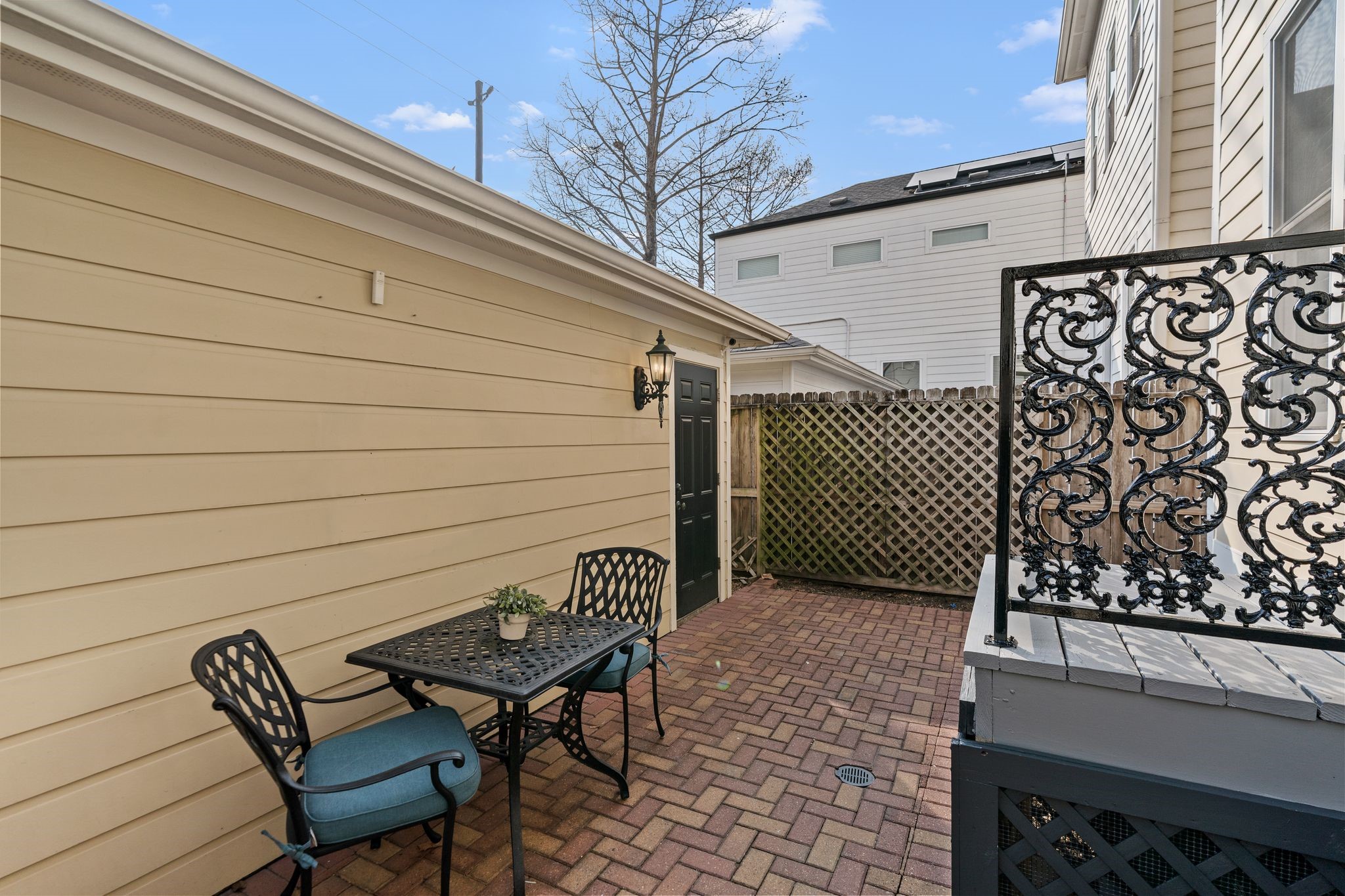 316 Aurora Street Houston, TX 77008 - Photo 24 of 31 The courtyard extends to the detached garage with convenient rear access, surrounded by brick paving and fencing for privacy. with room for a bistro table or additional seating, the space is ideal for casual outdoor gatherings without the maintenance of a traditional yard.