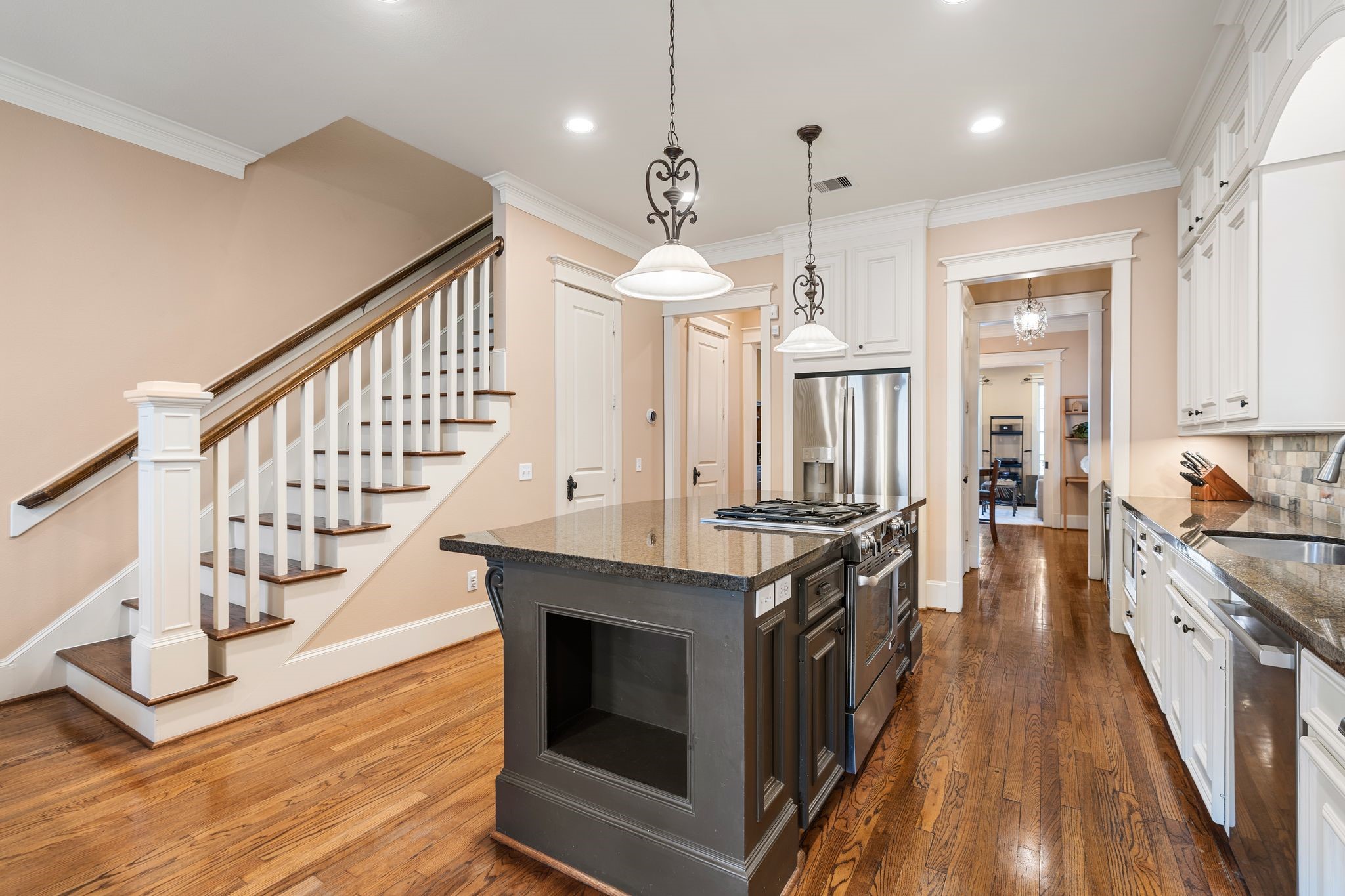 316 Aurora Street Houston, TX 77008 - Photo 8 of 31 Designed for both everyday living and entertaining, the kitchen layout offers generous prep space, a built-in Jenn Air gas range within the oversized island. There is also a Built in GE microwave and Bosch dishwasher. Kitchen has direct sight lines towards the staircase and adjoining living areas. The door opens to a large under-stair storage closet.