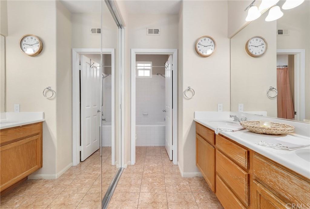 15 Marsala Irvine, CA 92606 - Photo 16 of 31 a bathroom with a granite countertop sink a mirror and a shower