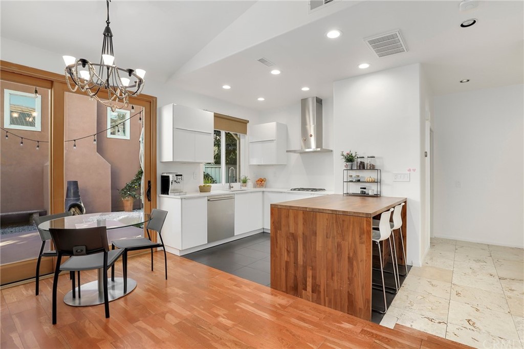 15 Marsala Irvine, CA 92606 - Photo 6 of 31 a kitchen with stainless steel appliances granite countertop a refrigerator a sink dishwasher a stove and white countertops with wooden floor