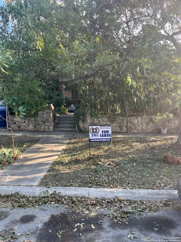 a wooden bench sitting in front of a building