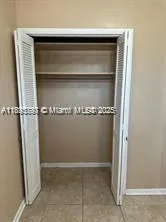 a bathroom with a granite countertop toilet a sink and a mirror
