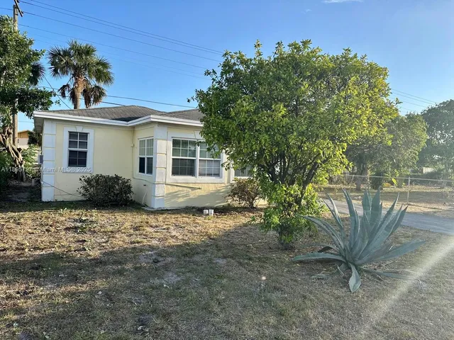 a view of a house with a tree in the background