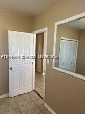 a view of a bathroom with mirror