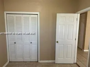 an empty room with wooden door