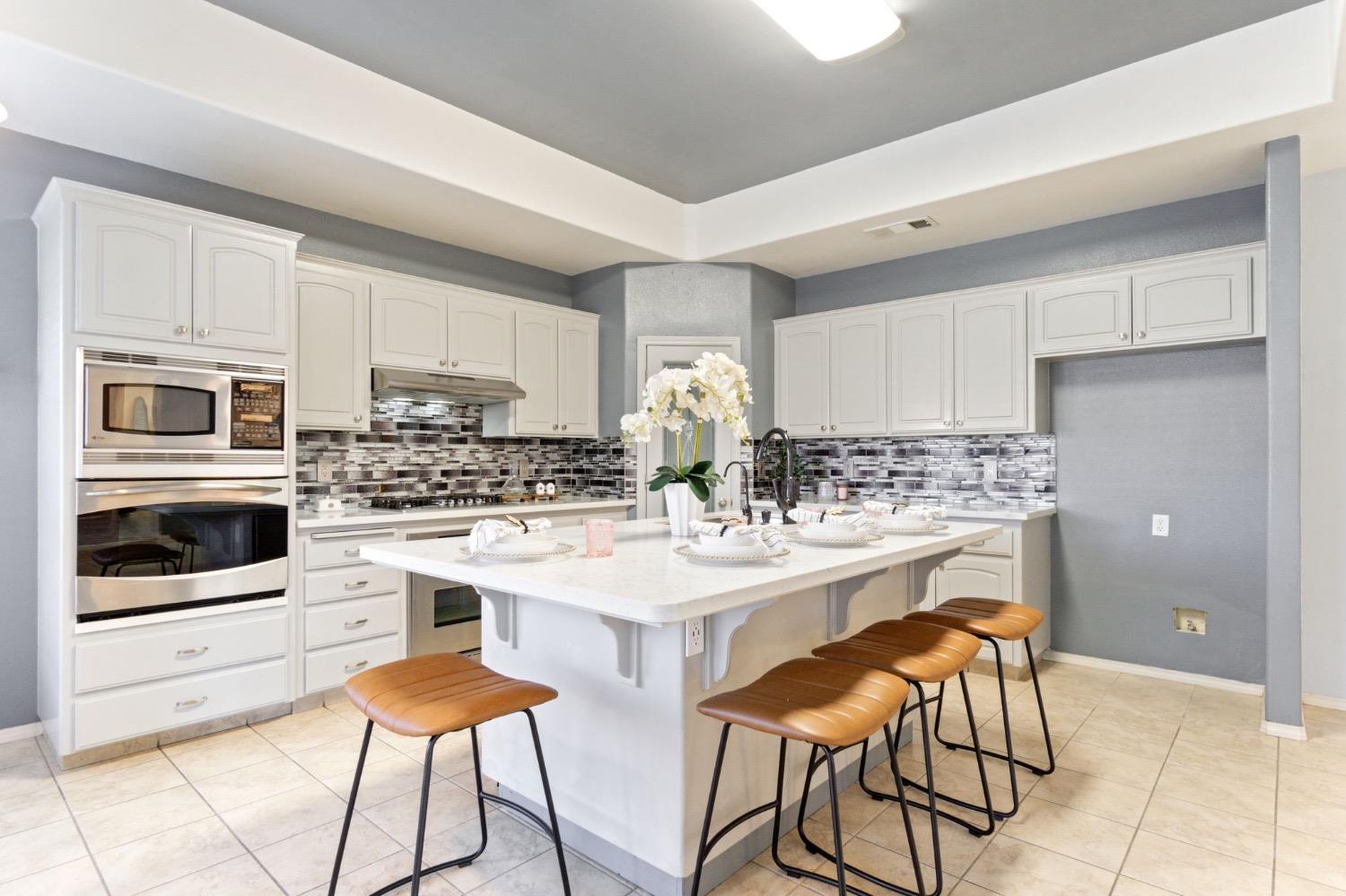 3089 Express Court Madera, CA 93637 - Photo 13 of 39 a kitchen with stainless steel appliances a stove a sink and a refrigerator