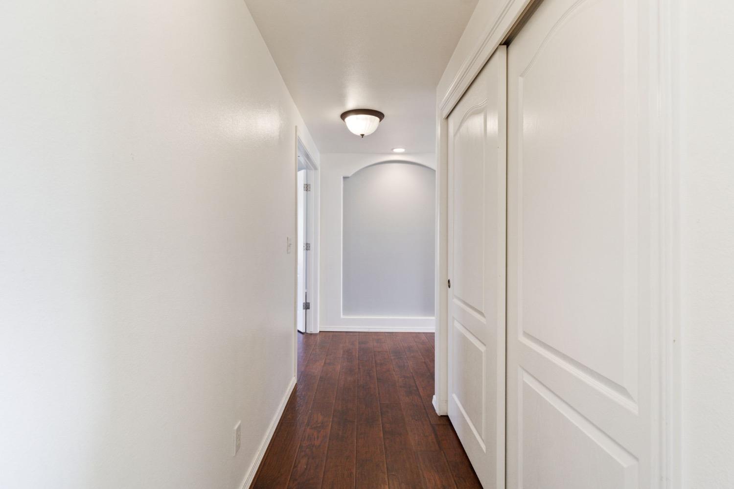 3089 Express Court Madera, CA 93637 - Photo 21 of 39 a view of a hallway with wooden floor