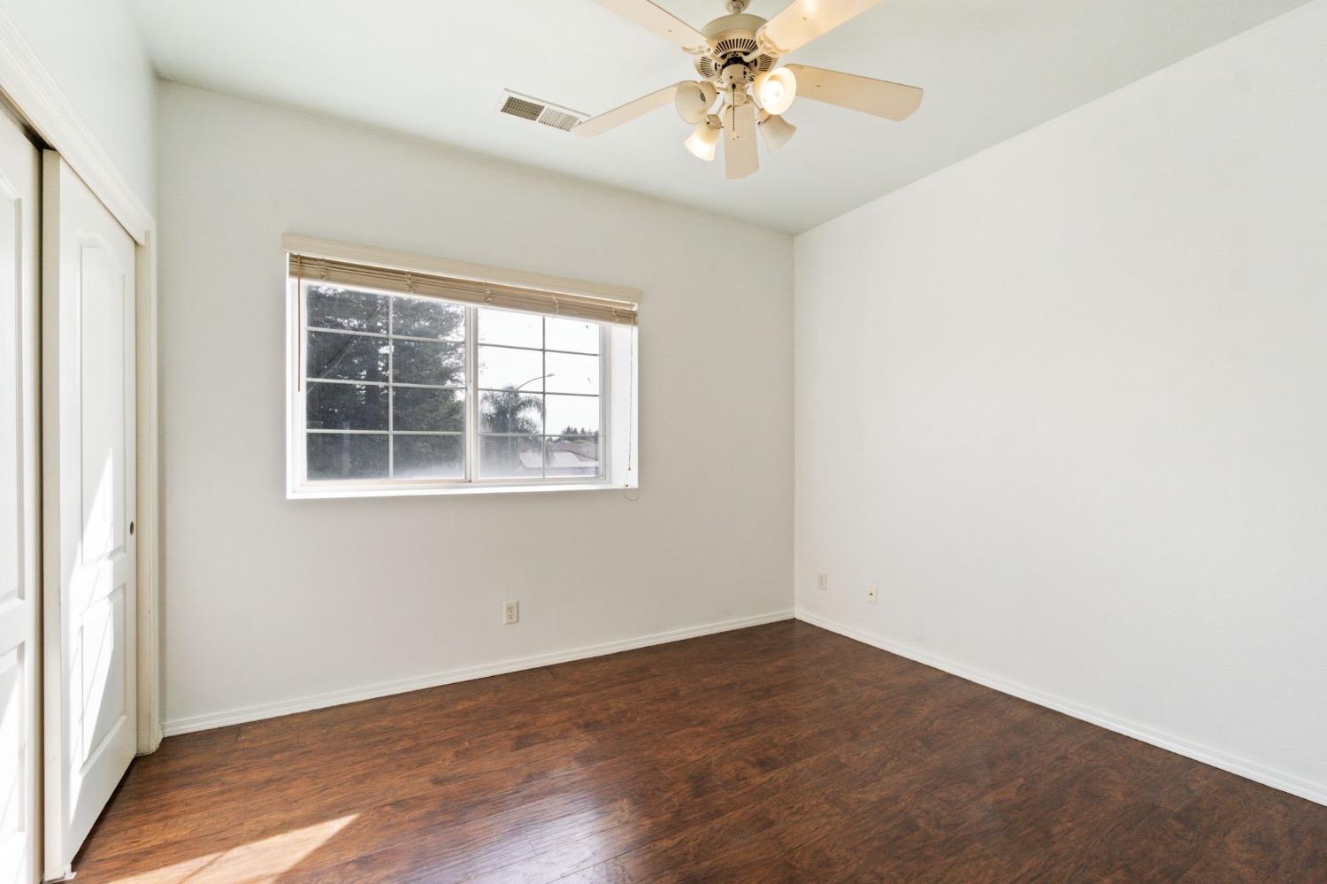 3089 Express Court Madera, CA 93637 - Photo 26 of 39 an empty room with a window and wooden floor