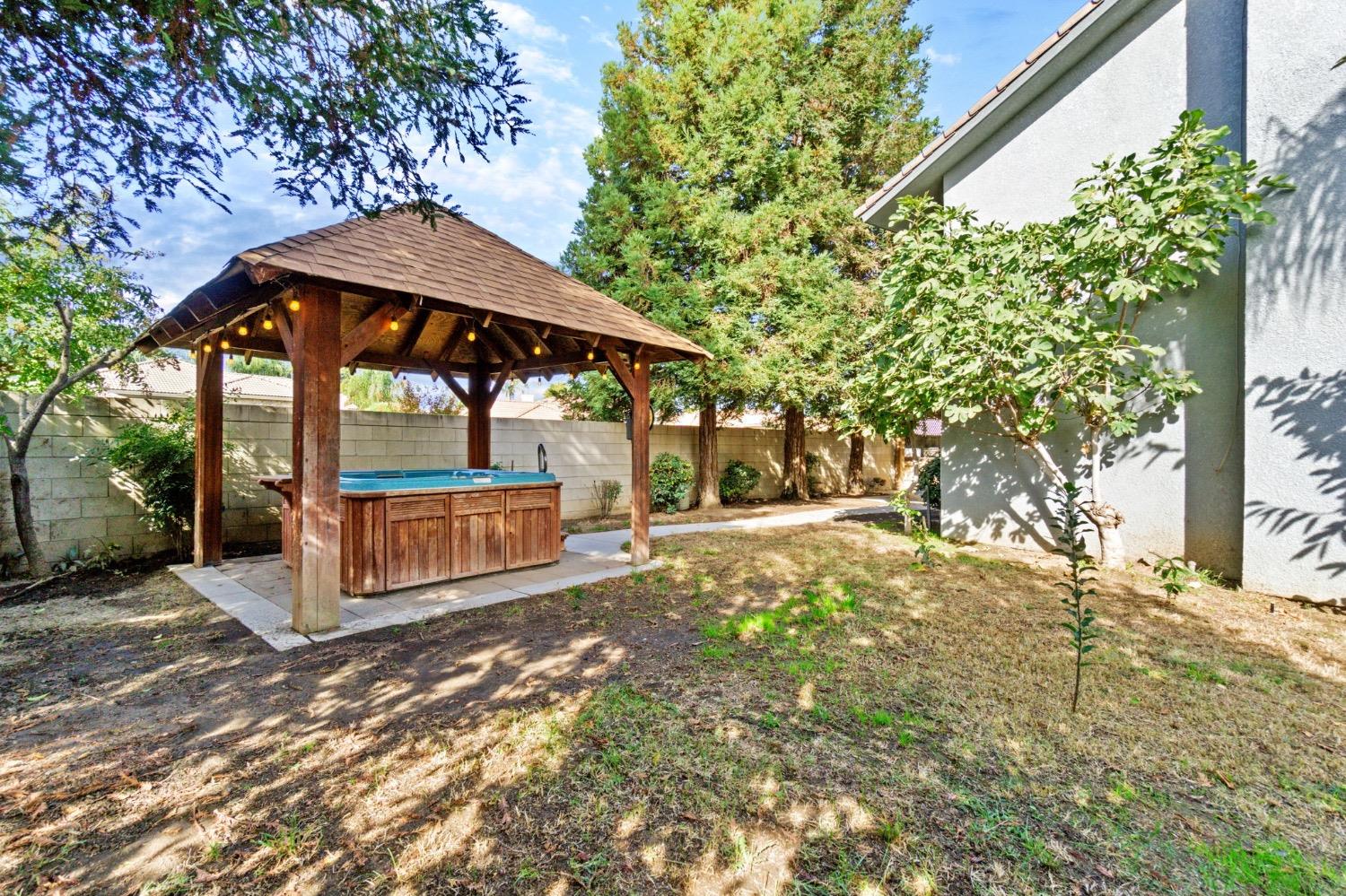 3089 Express Court Madera, CA 93637 - Photo 38 of 39 a view of backyard with a table and chairs under an umbrella