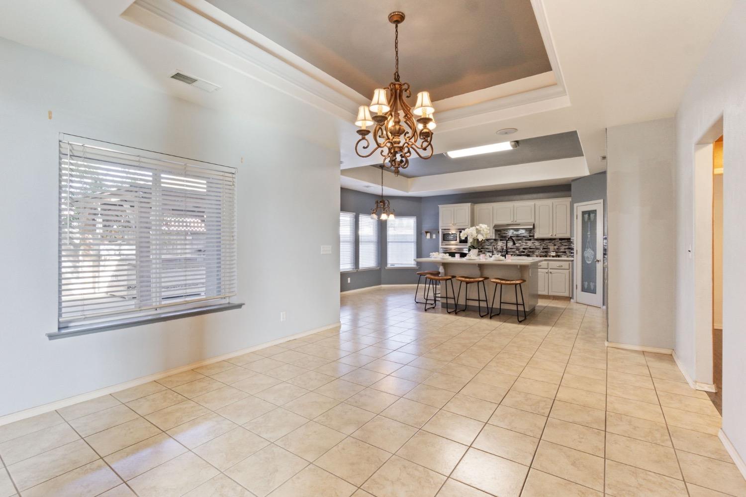 3089 Express Court Madera, CA 93637 - Photo 6 of 39 a view of a livingroom with a dinning table and chandelier