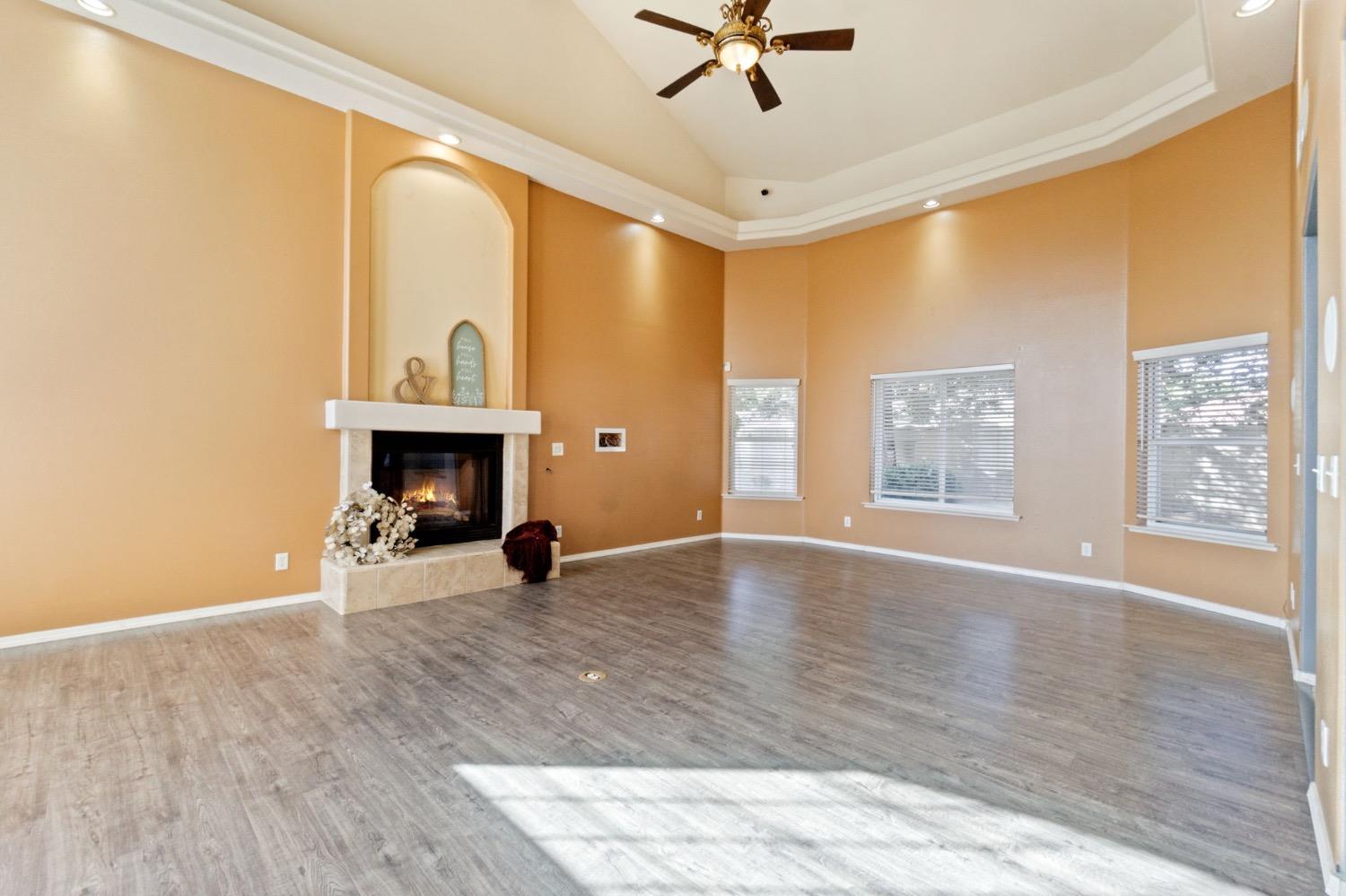 3089 Express Court Madera, CA 93637 - Photo 9 of 39 a view of an empty room with window and wooden floor