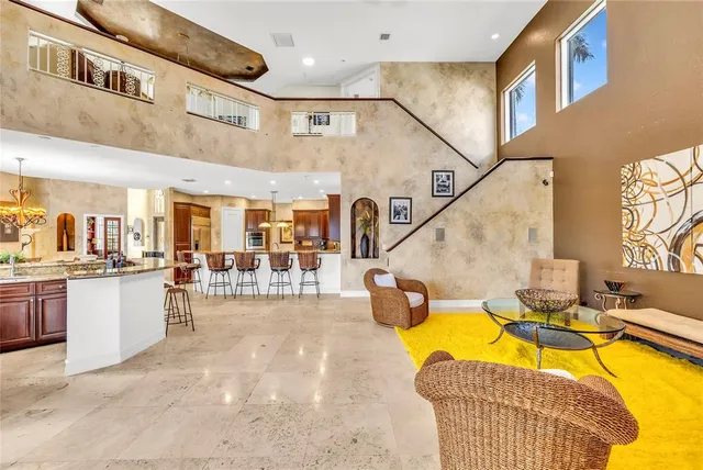 a living room with dining room and couches table