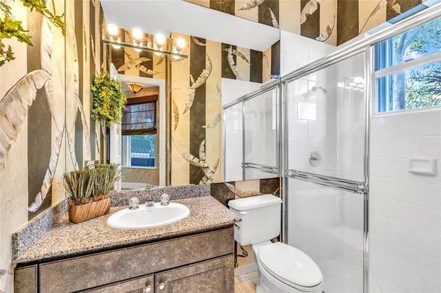 a living room with a bed and large couches with wooden floor