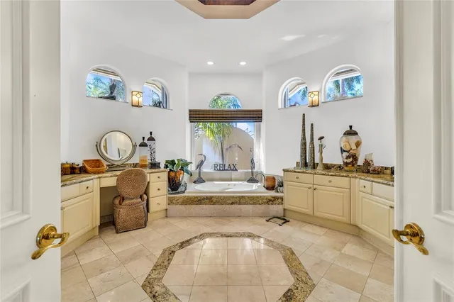a bathroom with a granite countertop sink a mirror and a shower