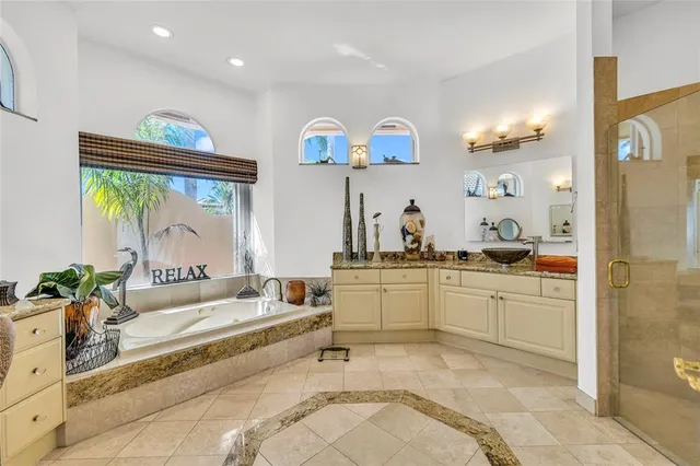a bedroom with a bed a dresser and wooden floor