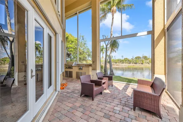 a view of a swimming pool with a lounge chair and palm trees