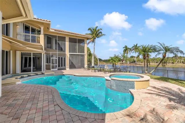 a view of a swimming pool with a garden and plants