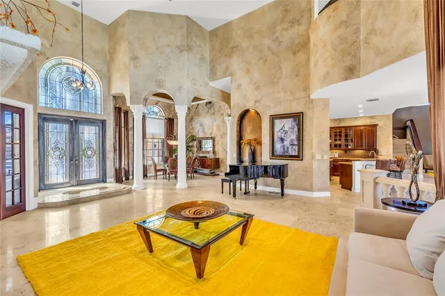 a living room with furniture pool table and sofas