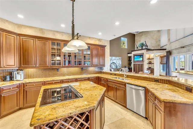 a large kitchen with stainless steel appliances granite countertop a sink and counter space