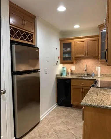 a kitchen with granite countertop stainless steel appliances and wooden cabinets