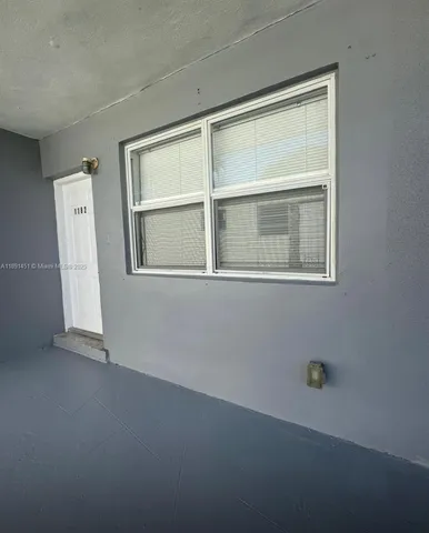 a view of an empty room with a window