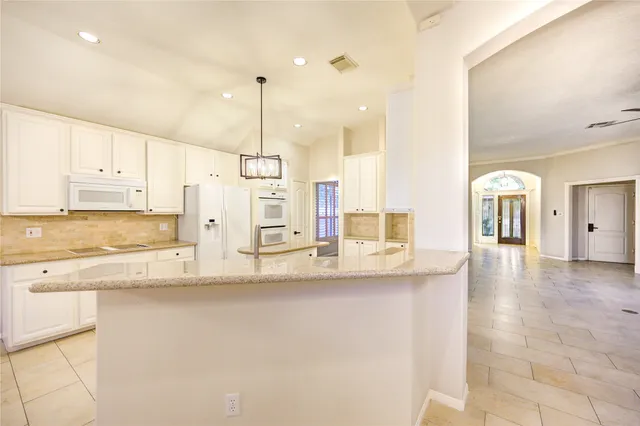 a view of a kitchen with a sink and a window