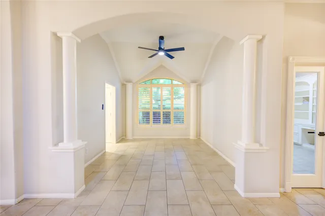 an empty room with fireplace and windows