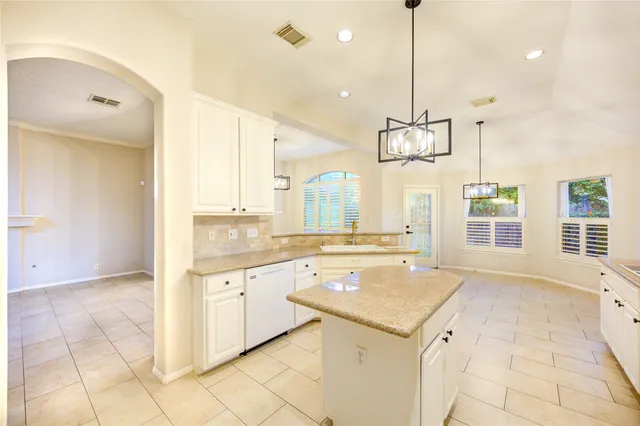 a view of a kitchen with granite countertop a sink and a stove