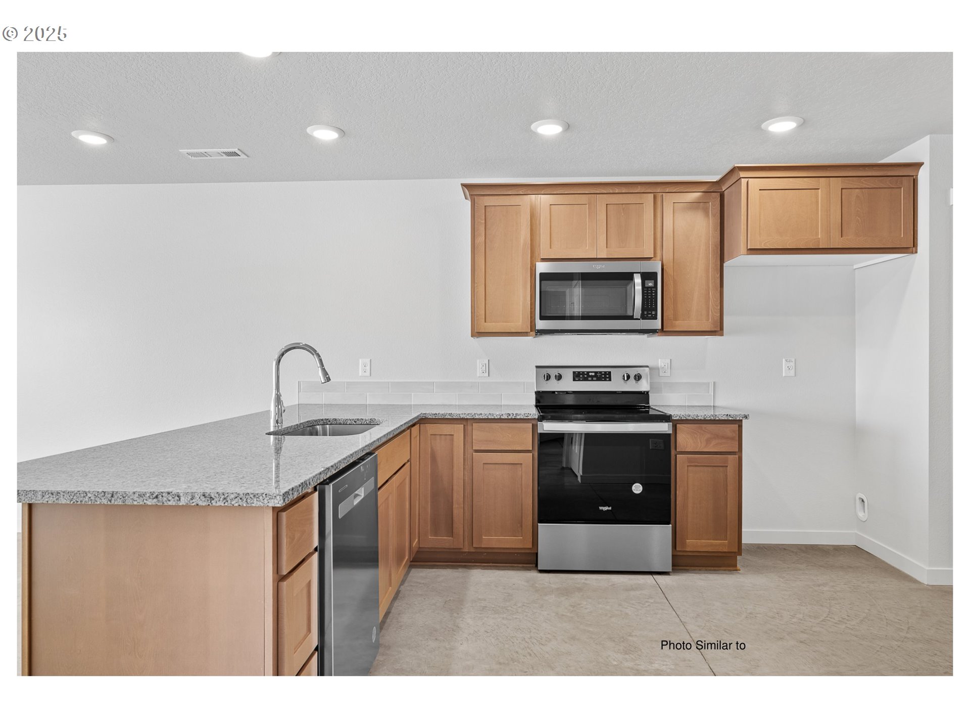 670 Jimmy Street Stanfield, OR 97875 - Photo 8 of 11 a kitchen with stainless steel appliances granite countertop a stove a sink and a microwave