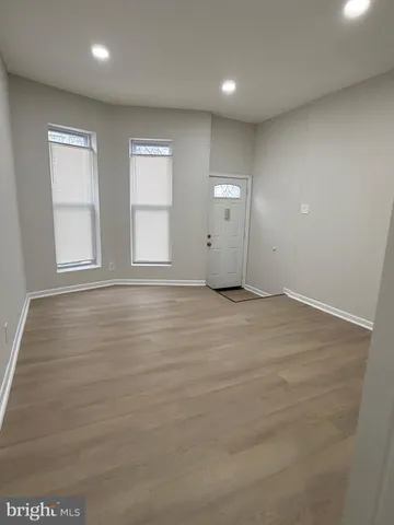 a view of hallway with wooden floor