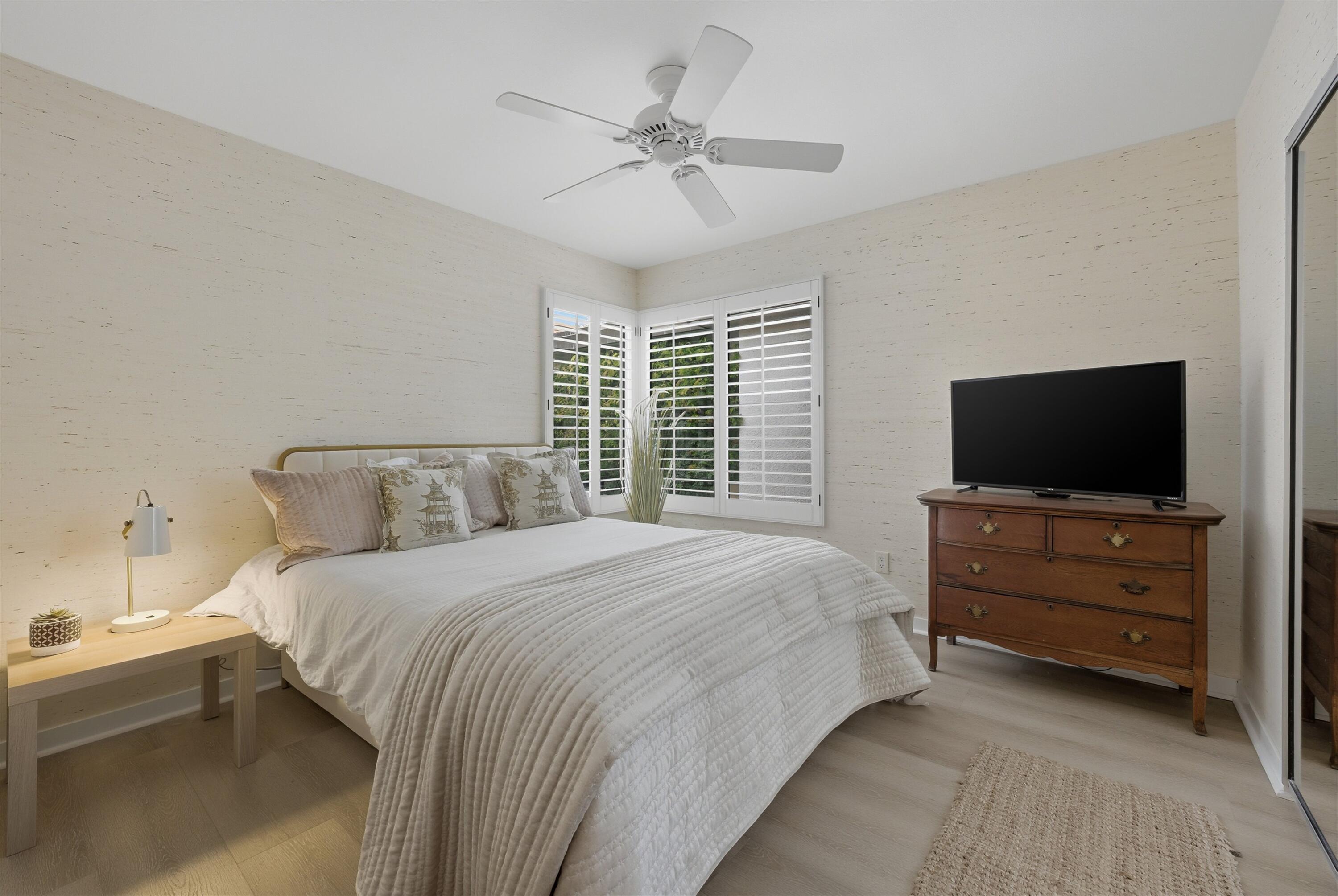 23 Leon Way Rancho Mirage, CA 92270 - Photo 17 of 32 a bedroom with a bed and a flat screen tv