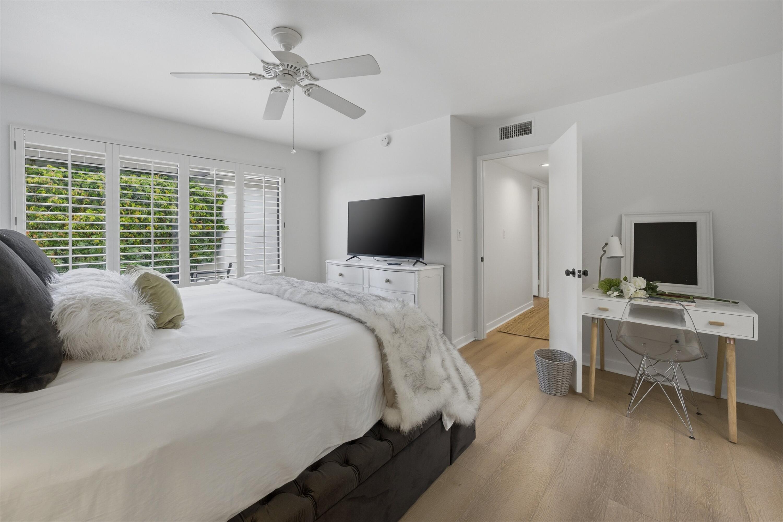 23 Leon Way Rancho Mirage, CA 92270 - Photo 19 of 32 a bedroom with a bed and a flat screen tv